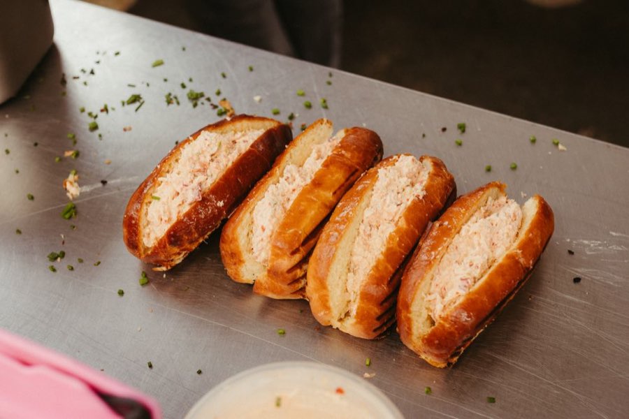 Small lobster rolls on a steel counter