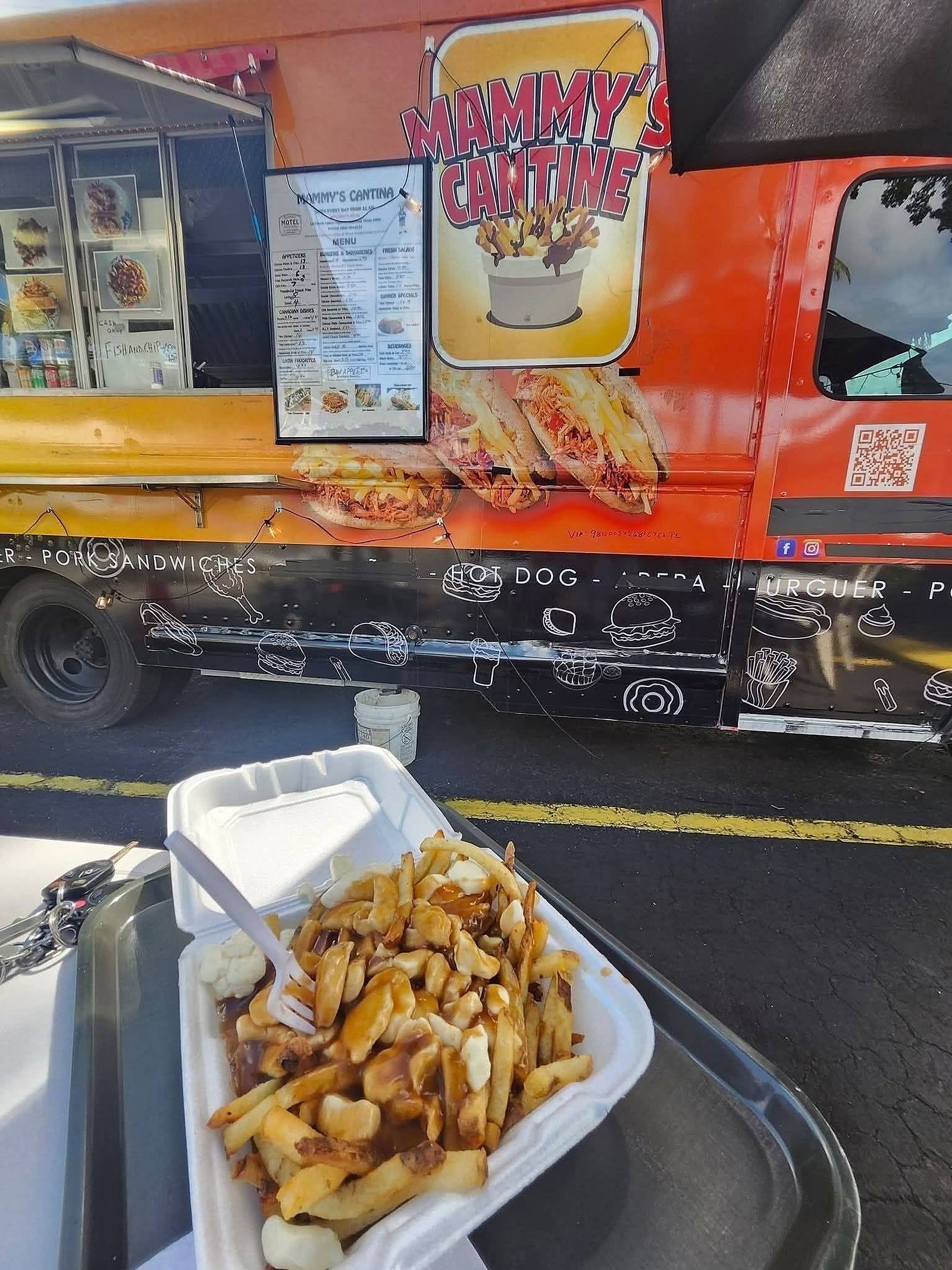 The Mammy's Cantine food truck with a fresh box of poutine in front